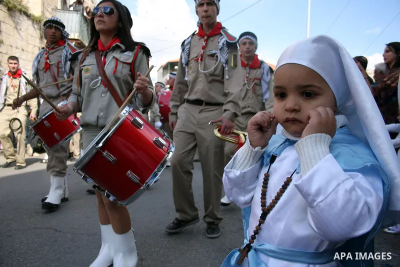 Scouts performs during Christian Orthodox annual celebrations of the "Holy Fire" in the West Bank city of Ramallah on the eve of Easter Sunday, April 23, 2011. The ceremony, celebrated in the same way for 11 centuries, i...