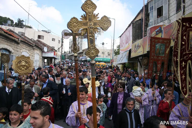 Palestinian Orthodox Christians gather on April 23, 2011, to take part in the 'Holy Fire' parade on the eve of the Orthodox Easter Sunday in the West Bank city of Ramallah in the Israeli occupied West Bank. Photo by Issa...