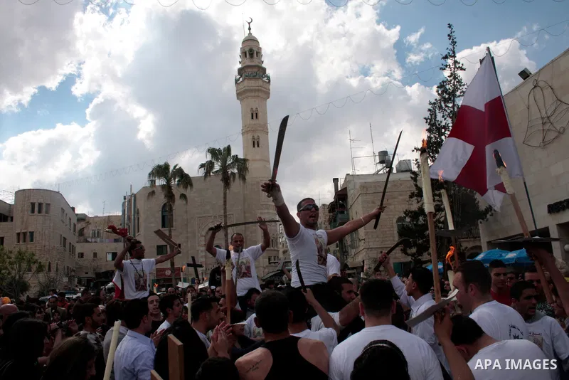 Christian Greek Orthodox take part in the 'Holy Fire' ceremony on the eve of the Orthodox Easter in the West Bank town of Bethlehem on April 23, 2011. Photo by Najeh Hashlamoun
