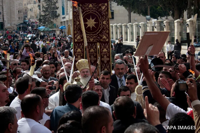 Christian Greek Orthodox take part in the 'Holy Fire' ceremony on the eve of the Orthodox Easter in the West Bank town of Bethlehem on April 23, 2011. Photo by Najeh Hashlamoun