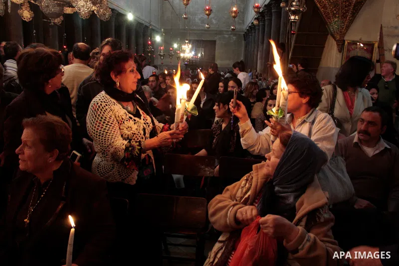 Christian Greek Orthodox take part in the 'Holy Fire' ceremony on the eve of the Orthodox Easter in the West Bank town of Bethlehem on April 23, 2011. Photo by Najeh Hashlamoun