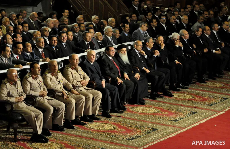 Egypt's presidential candidates Arab League Secretary-General Amr Moussa (R) and Mohamed el-Baradei sit during a Coptic Christian Easter service in the main cathedral in Cairo April 23, 2011. This year, the Orthodox and...