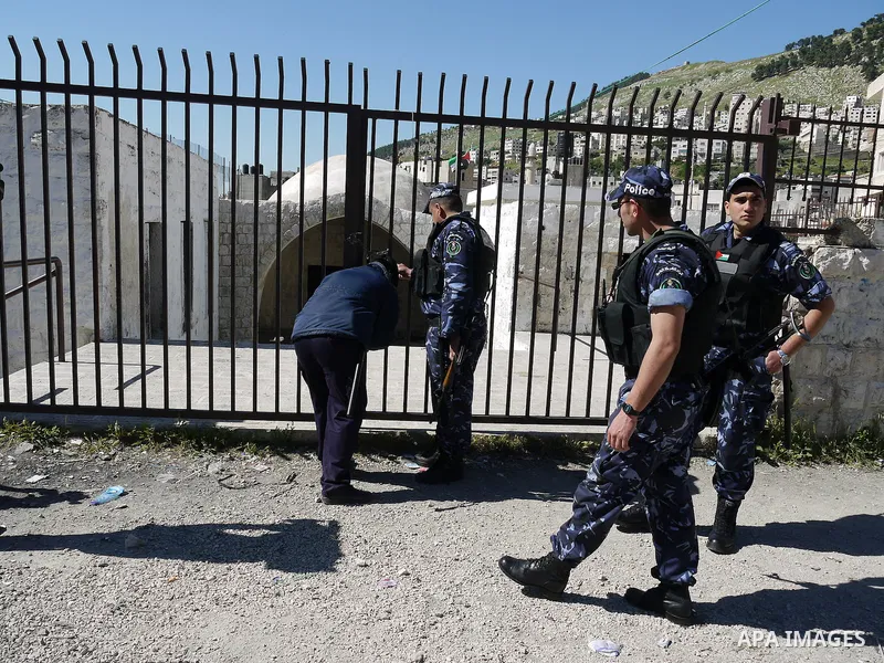 Members of the Palestinian police blocked the gate of "Joseph's Tomb" in Nablus, West Bank 24 April 2011.after his friend was shot dead by Palestinian policemen who fired on a group of Israeli pilgrims on their way to pr...