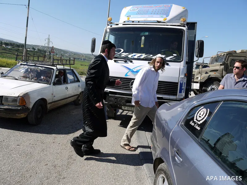 An ultra-Orthodox Jewish man shouts as he grieves next to an Israeli army base near the West Bank city of Nablus on April 24, 2011, after his friend was shot dead by Palestinian policemen who fired on a group of Israeli...