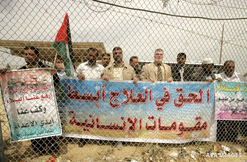 Palestinian doctors protest in front of the Rafah crossing border between Egypt and Gaza Strip on April ,27,2011, calling the new Egyptian government to open the crossing border for entering the medical needs. Photo by A...