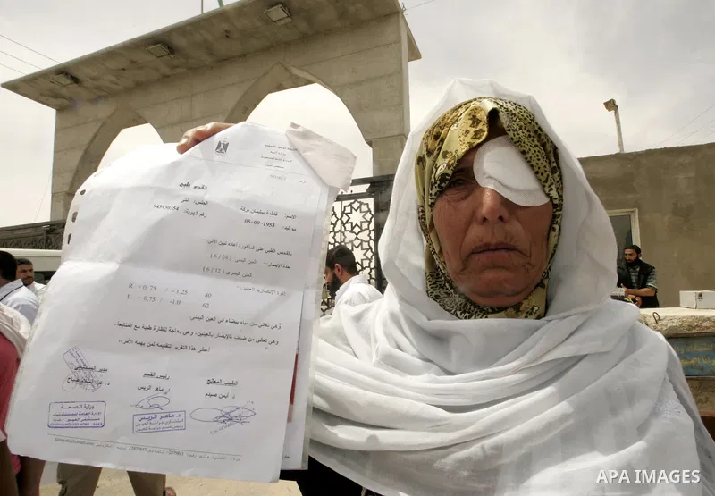 A Palestinian woman takes part in a protest organized by Palestinian doctors in front of the Rafah crossing border between Egypt and Gaza Strip on April ,27,2011, calling the new Egyptian government to open the crossing...
