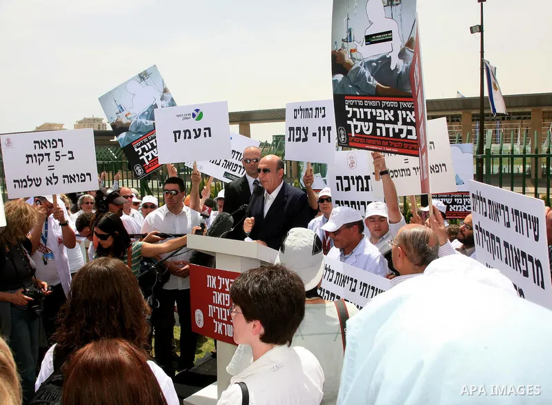 Israeli MK Shaul Mofaz takes part in a protest held by doctors and medical students from all over Israel, outside the Knesset in Jerusalem on April 27,2011 against the poor terms of their employment. Due to their strike...