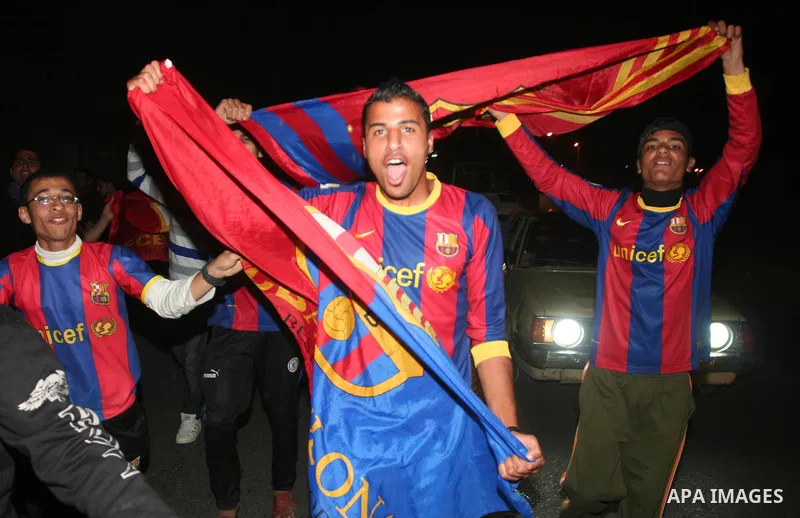 Palestinians youths celebrate the victory of the Spanish team Barcelona , in Gaza City on April. 27,2011. Barcelona celebrated their victory after the Spanish La Liga soccer match agalinst Real Madrid with Two goals. Pho...