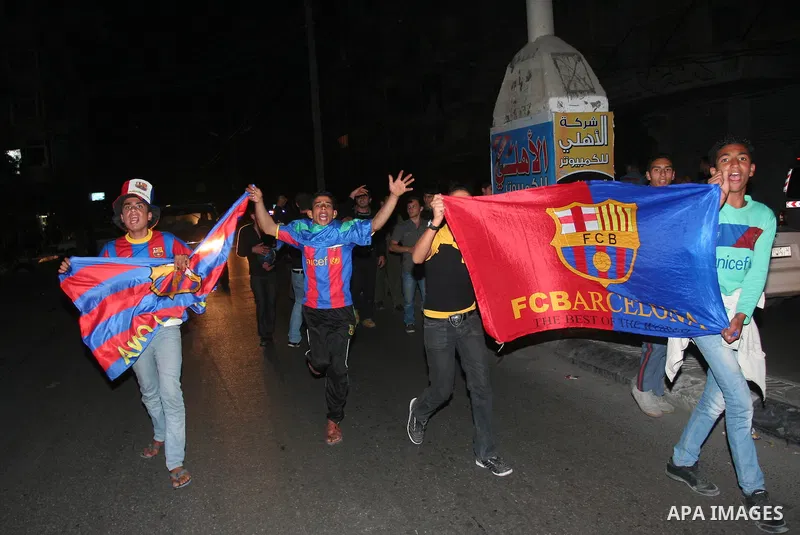 Palestinians youths celebrate the victory of the Spanish team Barcelona , in Gaza City on April. 27,2011. Barcelona celebrated their victory after the Spanish La Liga soccer match agalinst Real Madrid with Two goals. Pho...