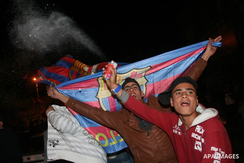 Palestinians youths celebrate the victory of the Spanish team Barcelona , in Gaza City on April. 27,2011. Barcelona celebrated their victory after the Spanish La Liga soccer match agalinst Real Madrid with Two goals. Pho...