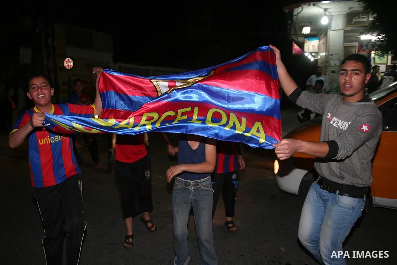 Palestinians youths celebrate the victory of the Spanish team Barcelona , in Gaza City on April. 27,2011. Barcelona celebrated their victory after the Spanish La Liga soccer match agalinst Real Madrid with Two goals. Pho...