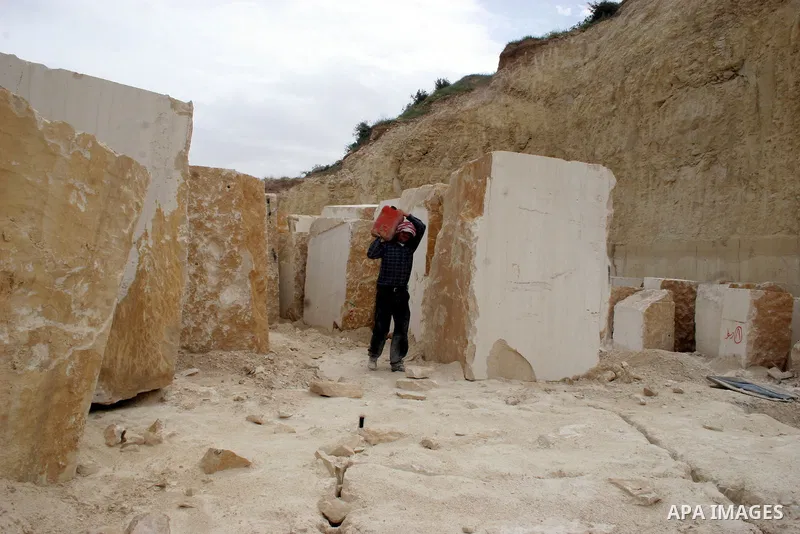 Palestinian labourers work at a quarry in the West Bank village of Taffouh near Hebron April 28, 2011. Stone and marble factories and quarries, located mainly in the West Bank cities of Bethlehem and Hebron, are at the c...