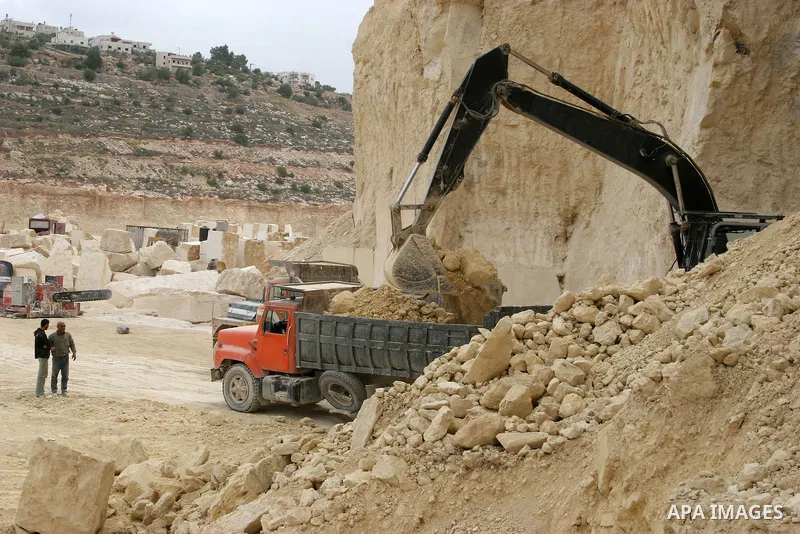 Palestinian labourers work at a quarry in the West Bank village of Taffouh near Hebron April 28, 2011. Stone and marble factories and quarries, located mainly in the West Bank cities of Bethlehem and Hebron, are at the c...