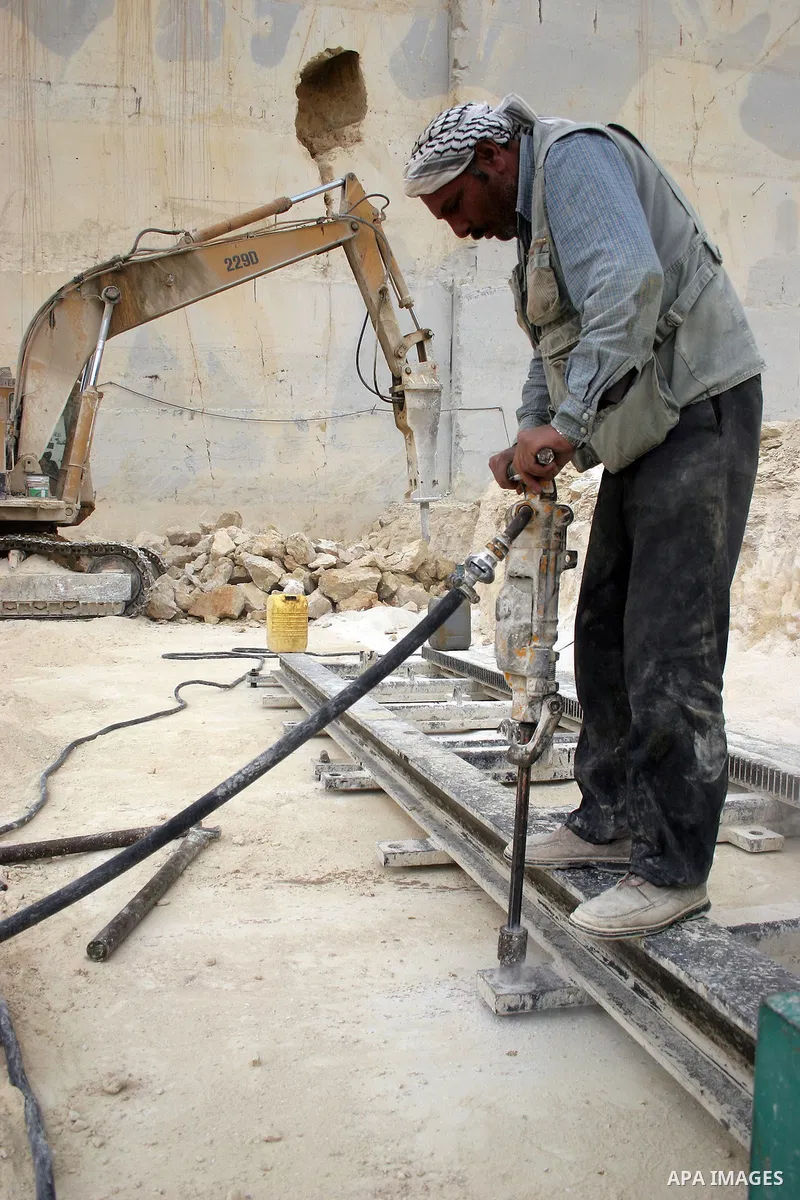 Palestinian labourers work at a quarry in the West Bank village of Taffouh near Hebron April 28, 2011. Stone and marble factories and quarries, located mainly in the West Bank cities of Bethlehem and Hebron, are at the c...