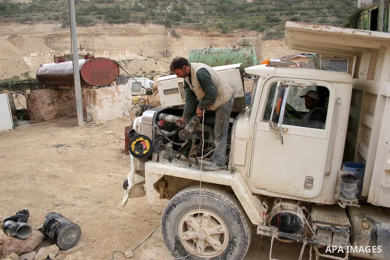 Palestinian labourers work at a quarry in the West Bank village of Taffouh near Hebron April 28, 2011. Stone and marble factories and quarries, located mainly in the West Bank cities of Bethlehem and Hebron, are at the c...