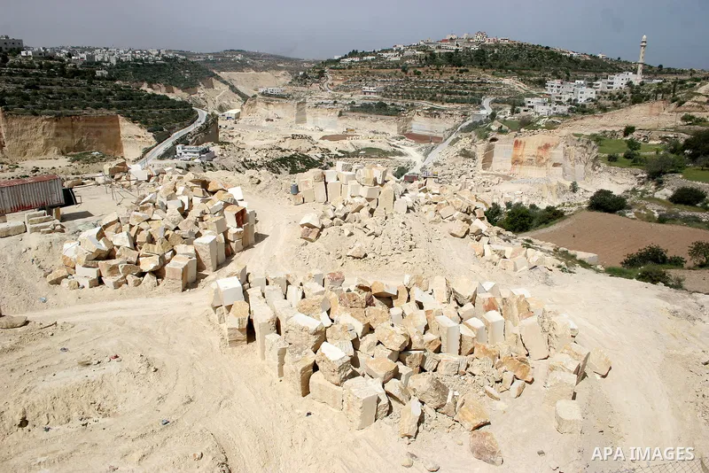 Palestinian labourers work at a quarry in the West Bank village of Taffouh near Hebron April 28, 2011. Stone and marble factories and quarries, located mainly in the West Bank cities of Bethlehem and Hebron, are at the c...
