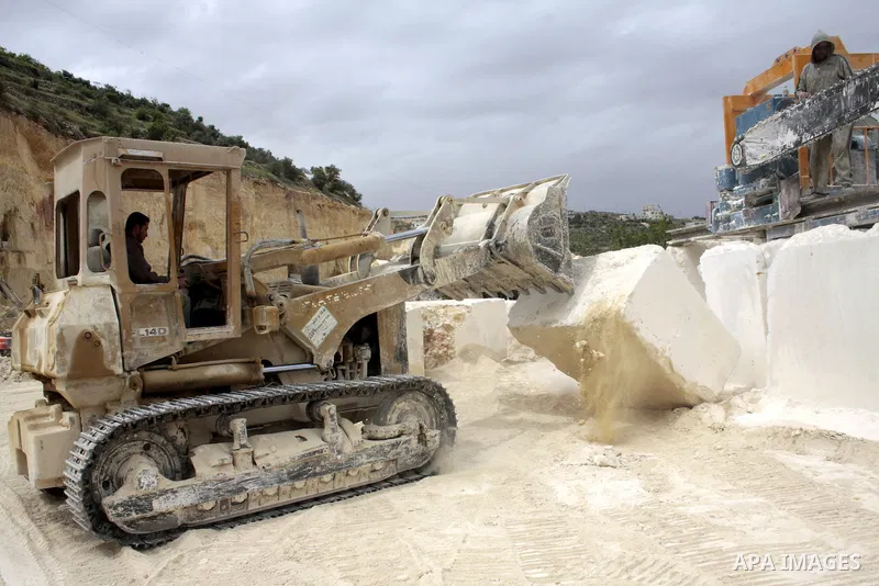 Palestinian labourers work at a quarry in the West Bank village of Taffouh near Hebron April 28, 2011. Stone and marble factories and quarries, located mainly in the West Bank cities of Bethlehem and Hebron, are at the c...