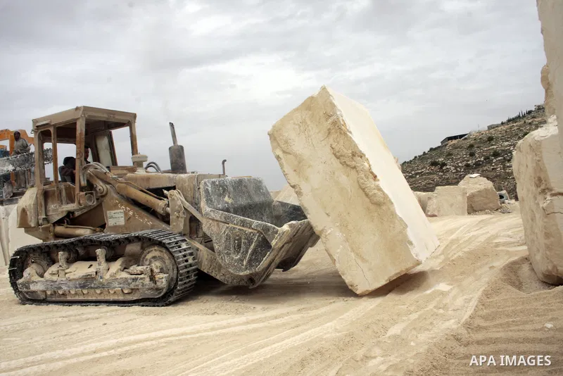 Palestinian labourers work at a quarry in the West Bank village of Taffouh near Hebron April 28, 2011. Stone and marble factories and quarries, located mainly in the West Bank cities of Bethlehem and Hebron, are at the c...