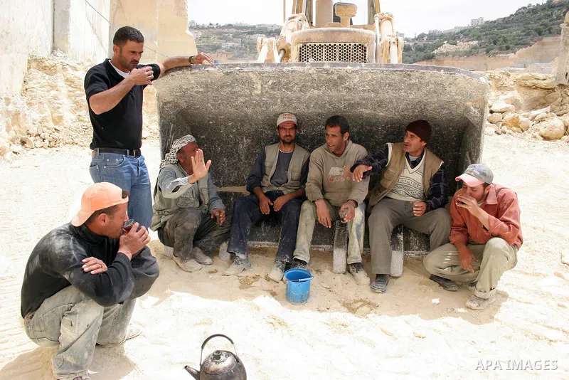 Palestinian labourers work at a quarry in the West Bank village of Taffouh near Hebron April 28, 2011. Stone and marble factories and quarries, located mainly in the West Bank cities of Bethlehem and Hebron, are at the c...