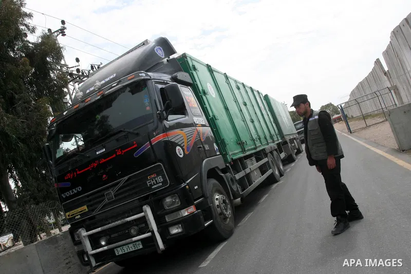 Palestinian policeman inspects the trucks loaded with goods and equipments after their arrival in the southern Gaza Strip through Kerem Shalom border crossing on April 28, 2011. Photo by Mohammed Asad