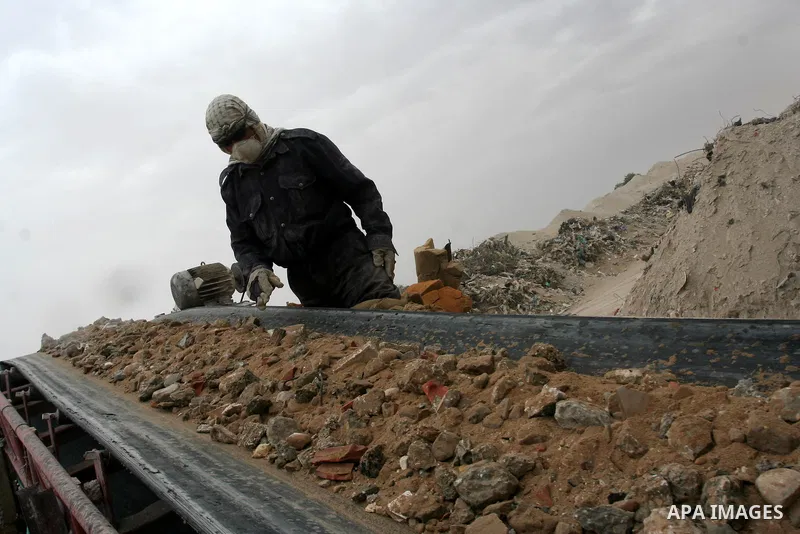 Palestinian workers smash large stones into small gravels to be used for building houses on April 28, 2011 in the southern Gaza Strip city of Khan Younis, as the coastal Palestinian territory continues to lack most const...