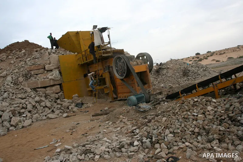Palestinian workers smash large stones into small gravels to be used for building houses on April 28, 2011 in the southern Gaza Strip city of Khan Younis, as the coastal Palestinian territory continues to lack most const...
