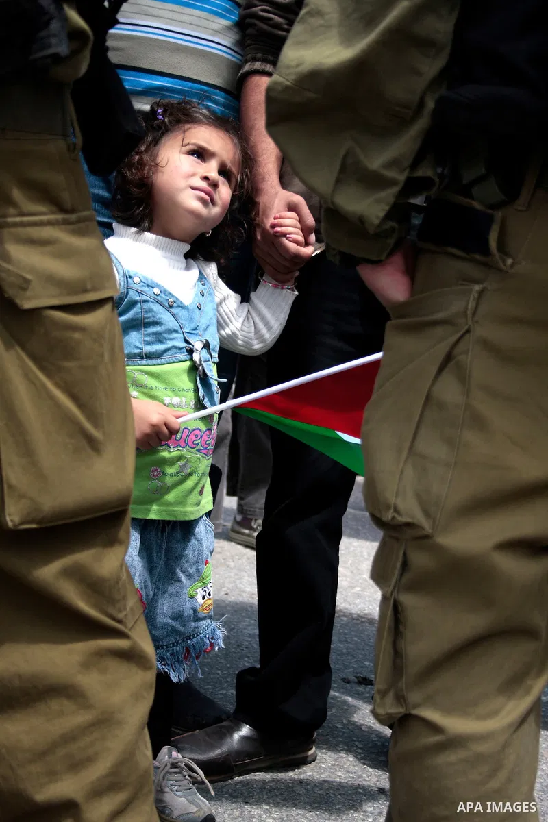 Protesters argue with Israeli soldiers during a demonstration against Israel's controversial separation barrier in the West Bank village of Maasarah, near the biblical town of Bethlehem on April 29, 2011.Israel says the...