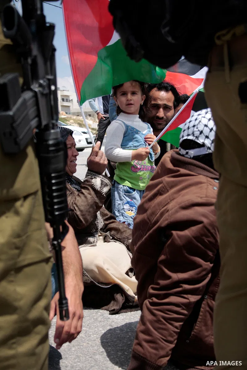 Protesters argue with Israeli soldiers during a demonstration against Israel's controversial separation barrier in the West Bank village of Maasarah, near the biblical town of Bethlehem on April 29, 2011.Israel says the...