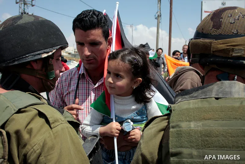 Protesters argue with Israeli soldiers during a demonstration against Israel's controversial separation barrier in the West Bank village of Maasarah, near the biblical town of Bethlehem on April 29, 2011.Israel says the...