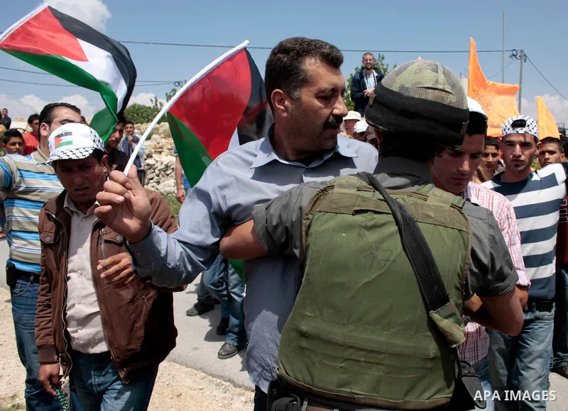 Protesters argue with Israeli soldiers during a demonstration against Israel's controversial separation barrier in the West Bank village of Maasarah, near the biblical town of Bethlehem on April 29, 2011.Israel says the...