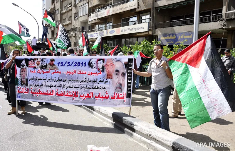 Egyptian protesters wave the Palestinian flag during a demonstration in front of the Israeli embassy in Cairo on April 29, 2011, calling for opening the border with the Gaza Strip and in support with Palestinian unity be...