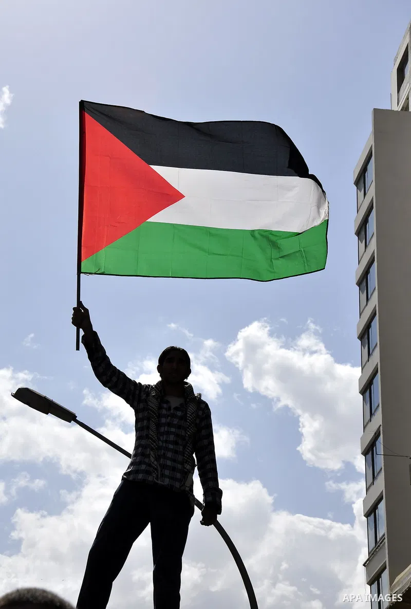 Egyptian protesters wave the Palestinian flag during a demonstration in front of the Israeli embassy in Cairo on April 29, 2011, calling for opening the border with the Gaza Strip and in support with Palestinian unity be...