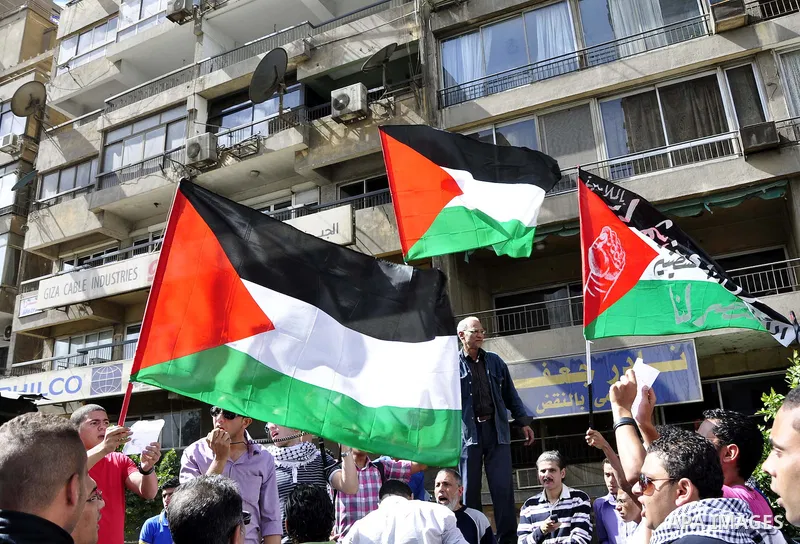 Egyptian protesters wave the Palestinian flag during a demonstration in front of the Israeli embassy in Cairo on April 29, 2011, calling for opening the border with the Gaza Strip and in support with Palestinian unity be...