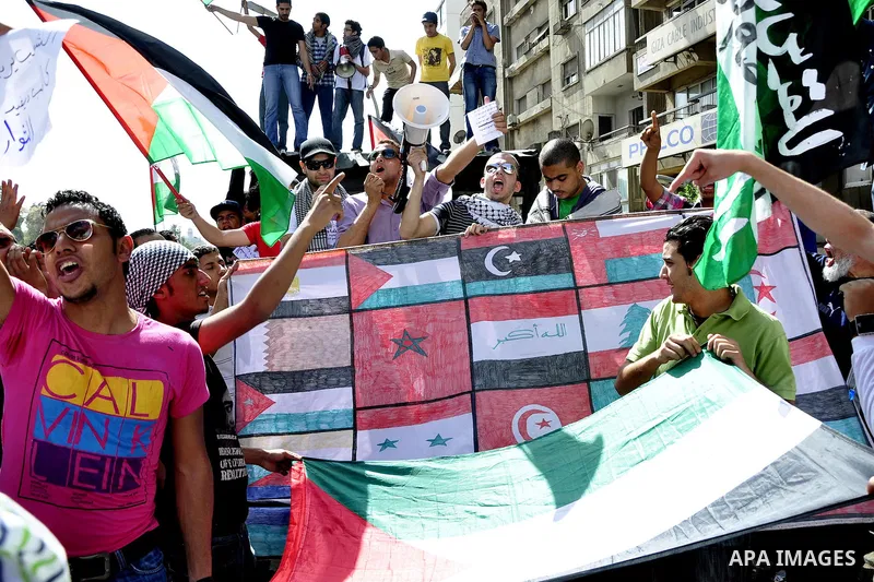 Egyptian protesters wave the Palestinian flag during a demonstration in front of the Israeli embassy in Cairo on April 29, 2011, calling for opening the border with the Gaza Strip and in support with Palestinian unity be...