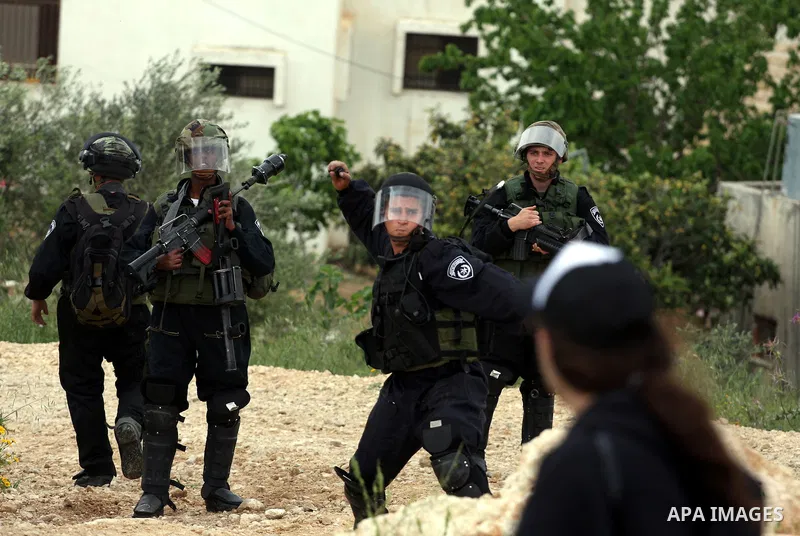 Israeli soldiers fire tear gas canisters toward demonstrators during protest against the expropriation of Palestinian land to expand the Jewish settlement of Halmish on April 29, 2011 in the West Bank village of Nabi Sal...