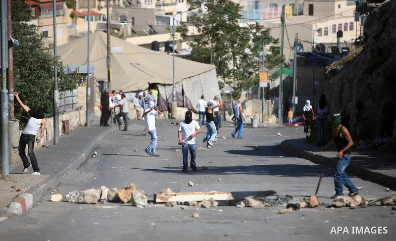 Palestinian youths hurl stones toward Israeli soldiers during clashes in the flashpoint east Jerusalem neighbourhood of Silwan on April 29, 2011.. Photo by Sliman Khader