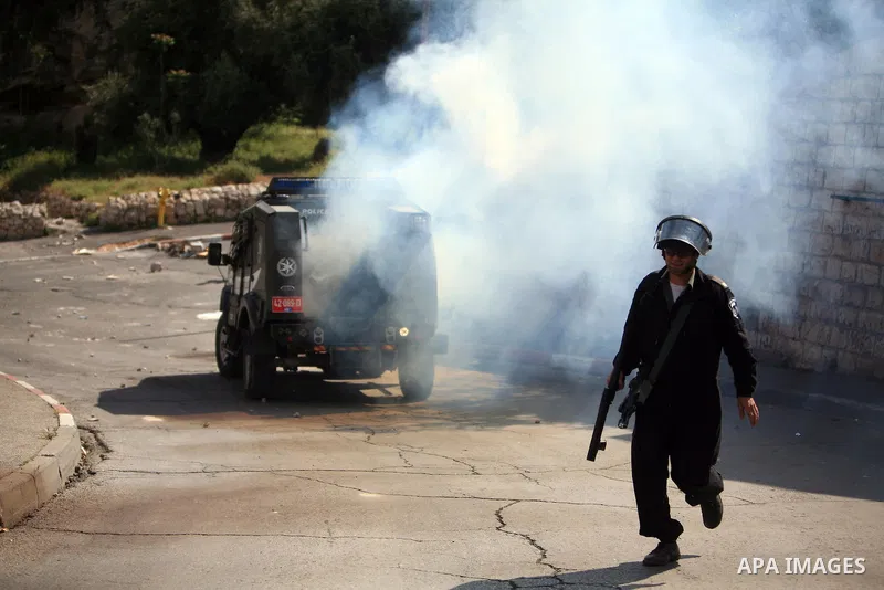 An Israeli soldier fires tear gas canisters towards Palestinian youths during clashes in the flashpoint east Jerusalem neighbourhood of Silwan on April 29, 2010.. Photo by Sliman Khader