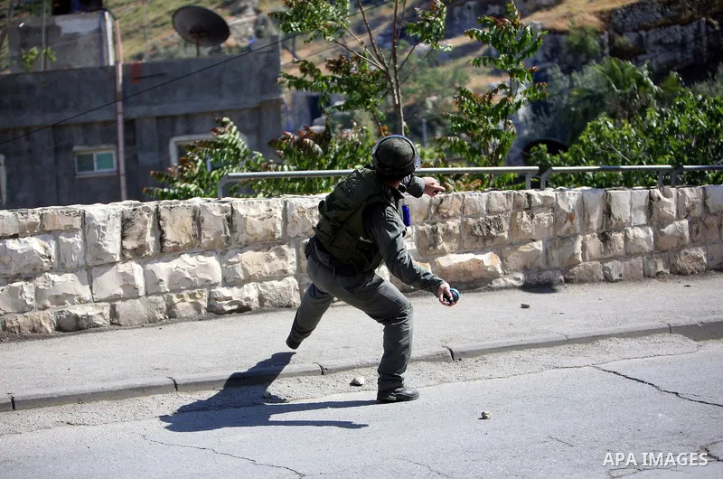 An Israeli soldier fires tear gas canisters towards Palestinian youths during clashes in the flashpoint east Jerusalem neighbourhood of Silwan on April 29, 2010.. Photo by Sliman Khader