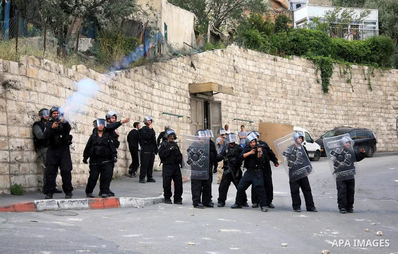 An Israeli soldier fires tear gas canisters towards Palestinian youths during clashes in the flashpoint east Jerusalem neighbourhood of Silwan on April 29, 2010.. Photo by Sliman Khader
