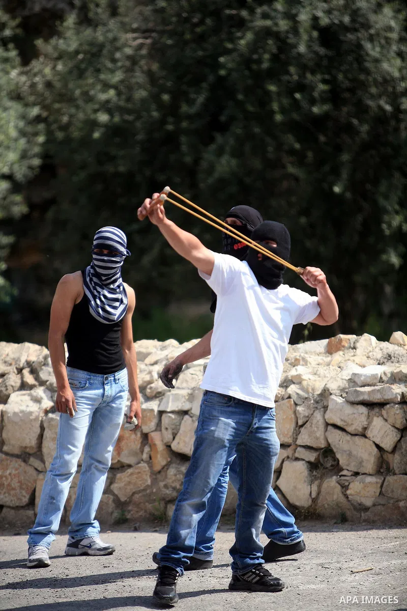 Palestinian youths hurl stones toward Israeli soldiers during clashes in the flashpoint east Jerusalem neighbourhood of Silwan on April 29, 2011.. Photo by Sliman Khader