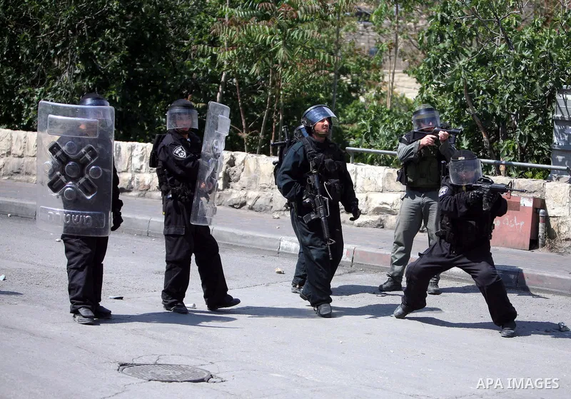 An Israeli soldier fires tear gas canisters towards Palestinian youths during clashes in the flashpoint east Jerusalem neighbourhood of Silwan on April 29, 2010.. Photo by Sliman Khader