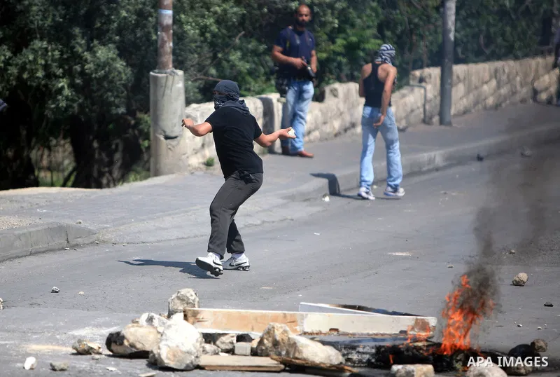 Palestinian youths hurl stones toward Israeli soldiers during clashes in the flashpoint east Jerusalem neighbourhood of Silwan on April 29, 2011.. Photo by Sliman Khader