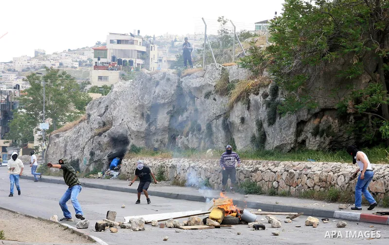 Palestinian youths hurl stones toward Israeli soldiers during clashes in the flashpoint east Jerusalem neighbourhood of Silwan on April 29, 2011.. Photo by Sliman Khader