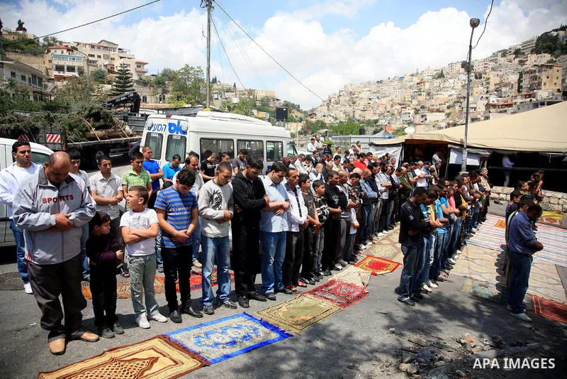 Palestinian Muslim worshipper attend Friday prayers near a protest tent in the mostly Arab neighbourhood of Silwan in east Jerusalem on April 29, 2010. Photo by Sliman Khader