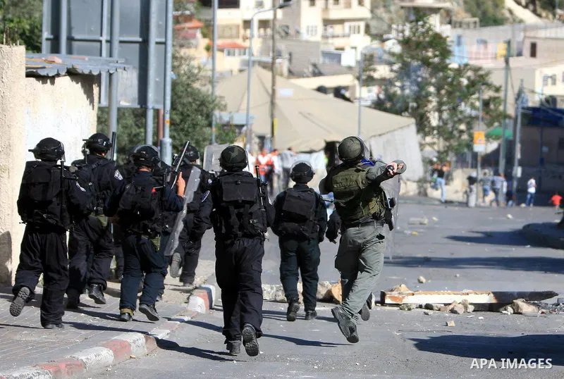 An Israeli soldier fires tear gas canisters towards Palestinian youths during clashes in the flashpoint east Jerusalem neighbourhood of Silwan on April 29, 2010.. Photo by Sliman Khader