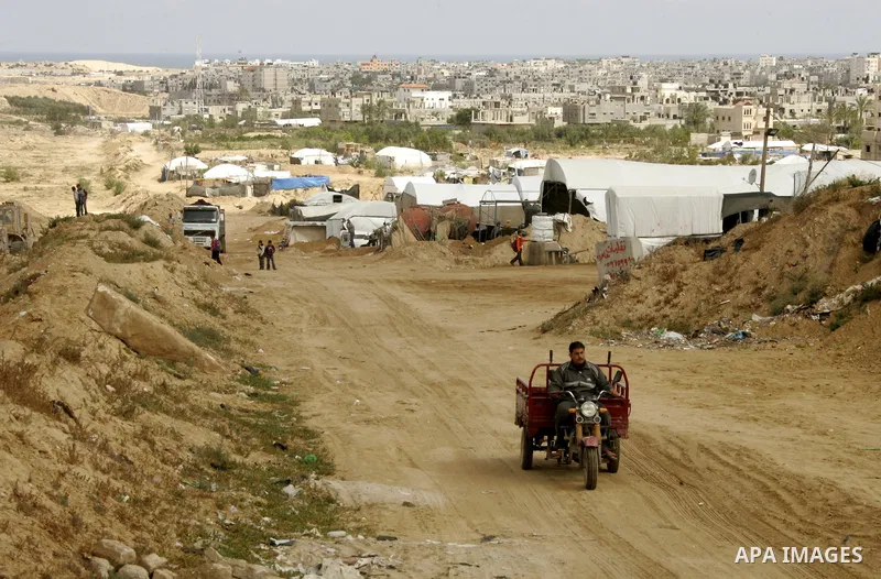 Palestinian boys walk near Rafah close to the border between Egypt and the southern Gaza Strip on April 30, 2011, a day after Egypt said it will permanently open the Rafah border crossing as part of its plans to ease the...