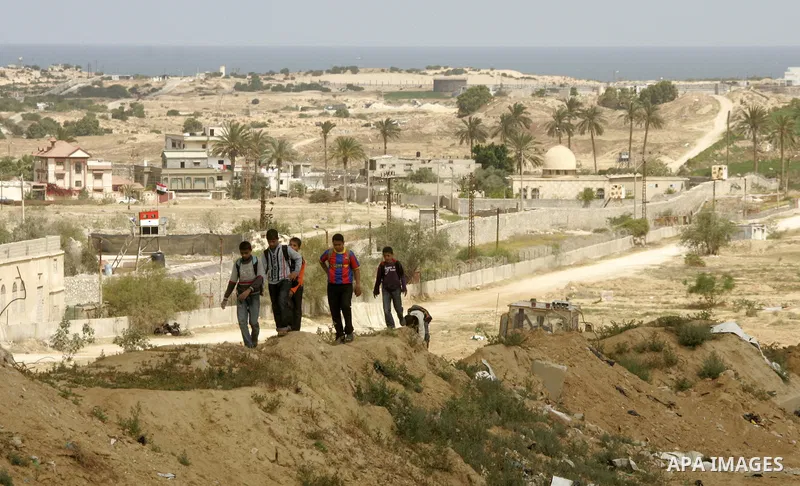 Palestinian boys walk near Rafah close to the border between Egypt and the southern Gaza Strip on April 30, 2011, a day after Egypt said it will permanently open the Rafah border crossing as part of its plans to ease the...