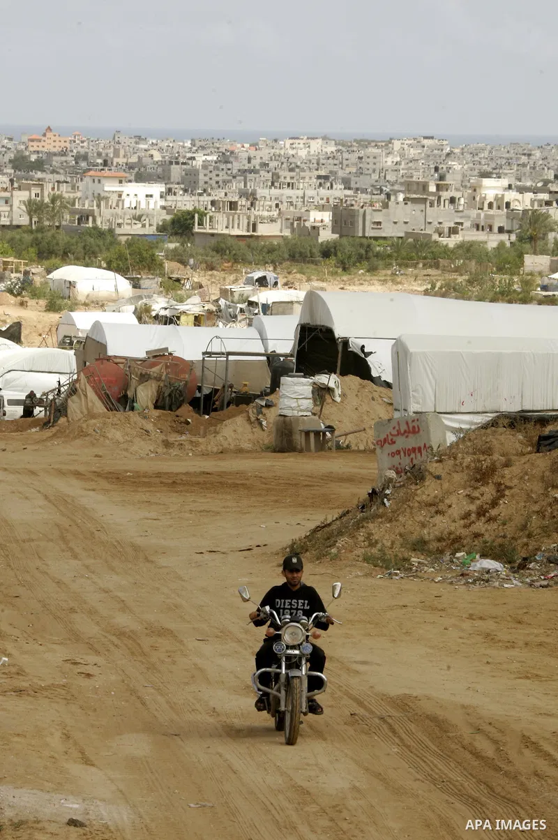 Palestinians walk near Rafah close to the border between Egypt and the southern Gaza Strip on April 30, 2011, a day after Egypt said it will permanently open the Rafah border crossing as part of its plans to ease the blo...