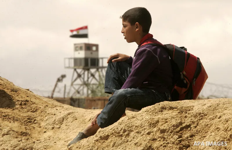 Palestinian boys walk near Rafah close to the border between Egypt and the southern Gaza Strip on April 30, 2011, a day after Egypt said it will permanently open the Rafah border crossing as part of its plans to ease the...