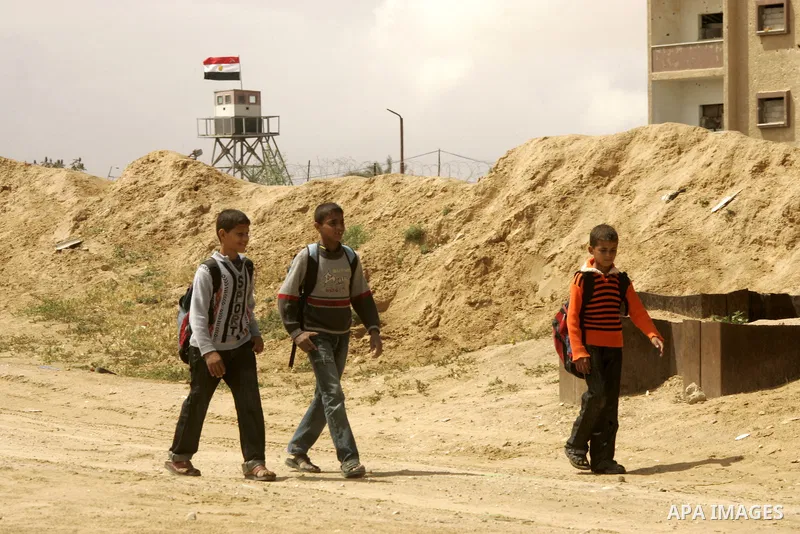 Palestinian boys walk near Rafah close to the border between Egypt and the southern Gaza Strip on April 30, 2011, a day after Egypt said it will permanently open the Rafah border crossing as part of its plans to ease the...